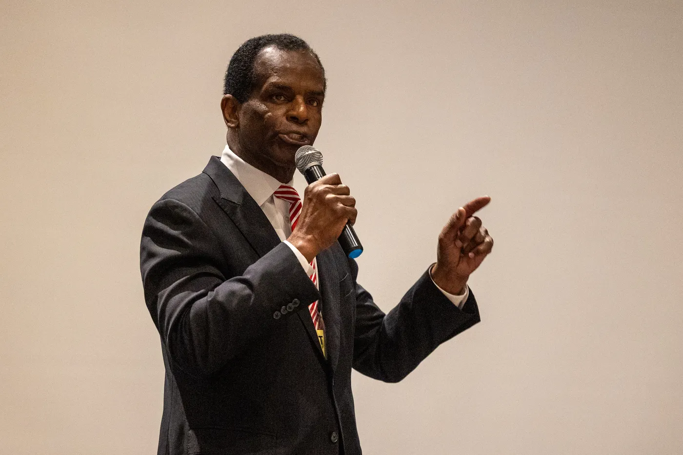 A speaker addresses the 2026 Fairfax County Republican Convention, microphone in hand.