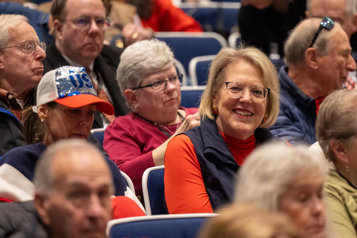Fairfax Republican members smile and laugh together in the audience at the 2026 County Convention.